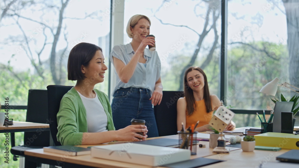 Relaxed team coworkers talking at break in office close up. Colleagues laughing Relaxed team coworkers talking at break in office close up. Colleagues laughing