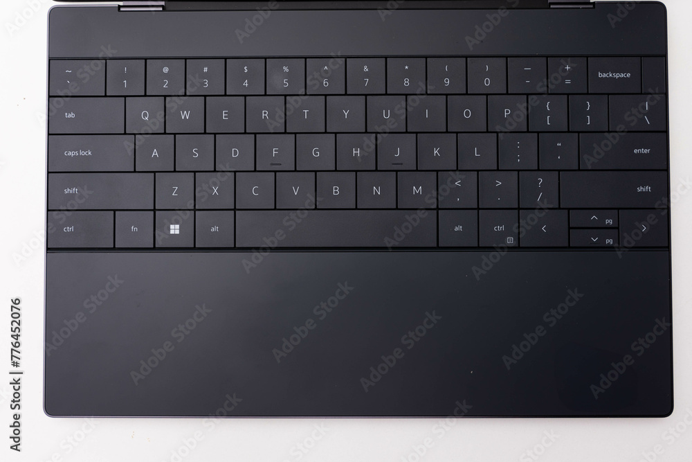 Close-up of a sleek, contemporary modern black laptop keyboard with chiclet keys, featuring a minimalist and portable design, perfect for productivity and work tool in the office Close-up of a sleek, contemporary modern black laptop keyboard with chiclet keys, featuring a minimalist and portable design, perfect for productivity and work tool in the office