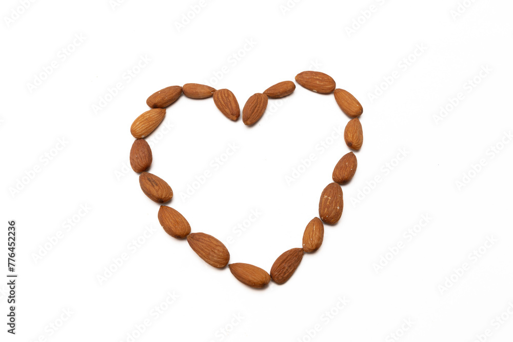 Almonds arranged in a heart shape, isolated on a white background, symbolizing healthy eating