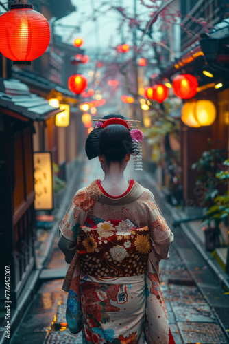 A graceful figure in elaborate kimono absorbs the ancient spirit of lantern-lit streets of an old Japanese alleys.