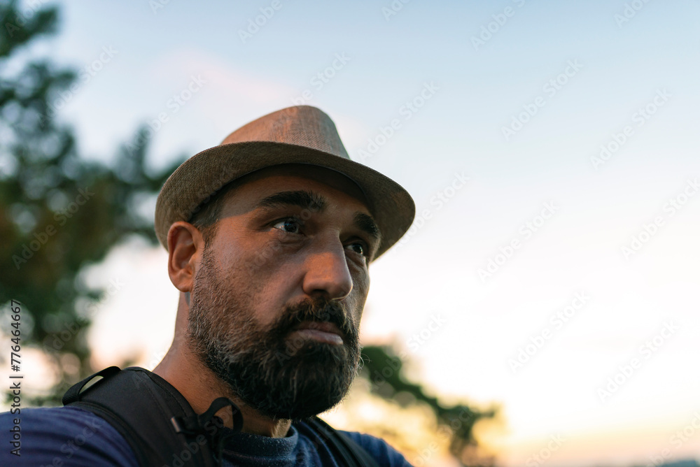 Handsome Mature Man with Beard and Hat During a Sunset in the City