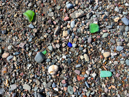 Seaglass in different colors among the pebbles on a beach along the Bay of Fundy, New Brunswick, Canada