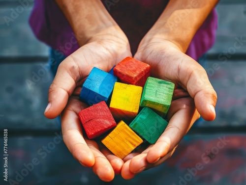 A person holding a handful of colorful wooden blocks in their hands. Generative AI.