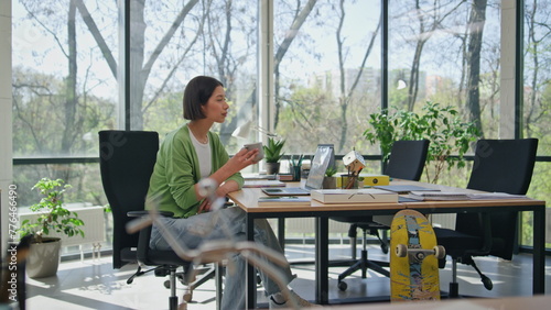 Businesswoman taking coffee break sitting office desk. Woman creator relaxing