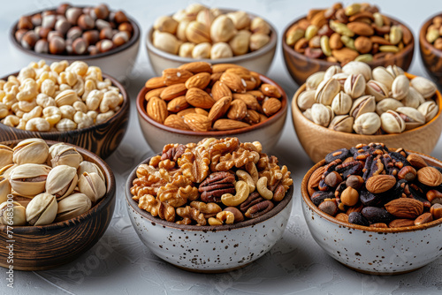 A collection of assorted nuts in small bowls isolated on a white background. Concept of healthy snacking. Generative Ai.