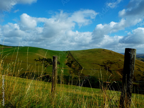 Tranquil Countryside Bliss: Rolling Hills and Rustic Wire Fences in Picturesque Landscape!
