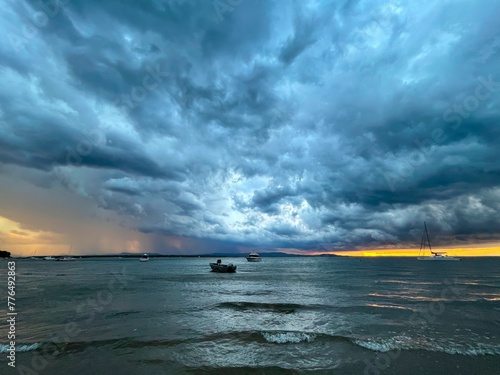 Storm out at sea with boats during sunset, Seventeen Seventy, Queensland, Australia