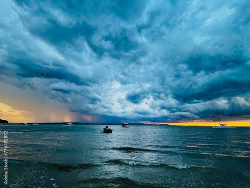 Storm out at sea with boats during sunset, Seventeen Seventy, Queensland, Australia