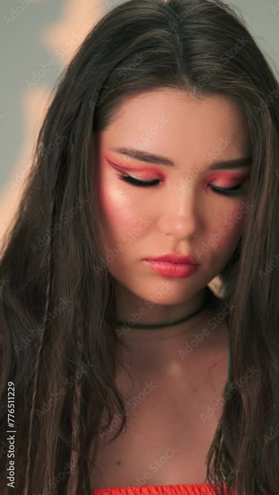 Vertical portrait of a young model with long black hair and bright makeup Vertical portrait of a young model with long black hair and bright makeup