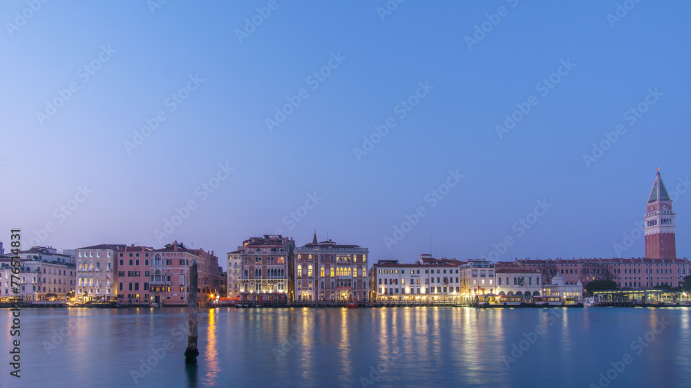 Panoramic view from Canal Grande at Campanile and facades of typical buildings during blue hour, Venice, Veneto, Italy