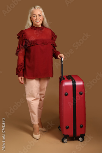 Senior woman with suitcase ...