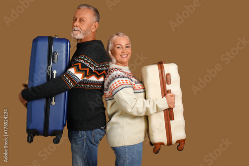 Senior couple with suitcase...