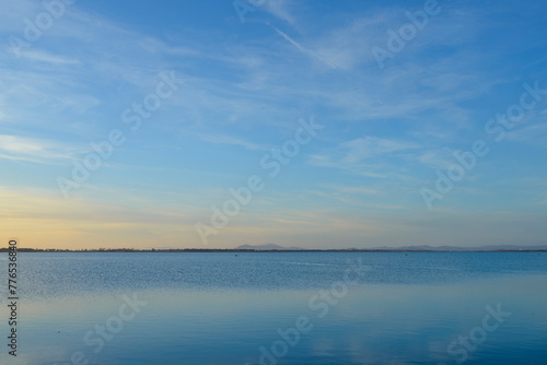 Sky, earth and sea. Panoramic sunset in Orbetello lagoon in Maremma Tuscany, Italy