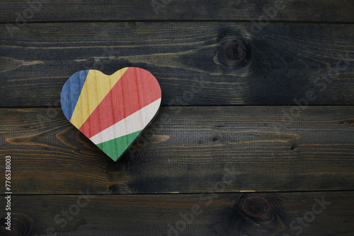 wooden heart with national flag of seychelles on the wooden background.