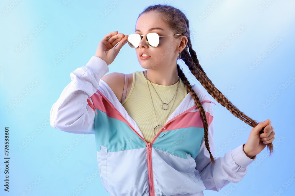 Beautiful young woman with stylish sunglasses on blue background Beautiful young woman with stylish sunglasses on blue background