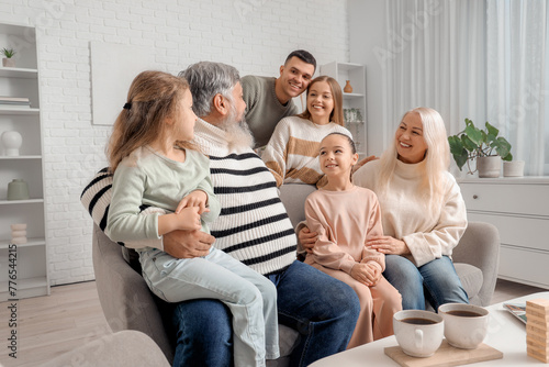 Big family sitting on sofa ...
