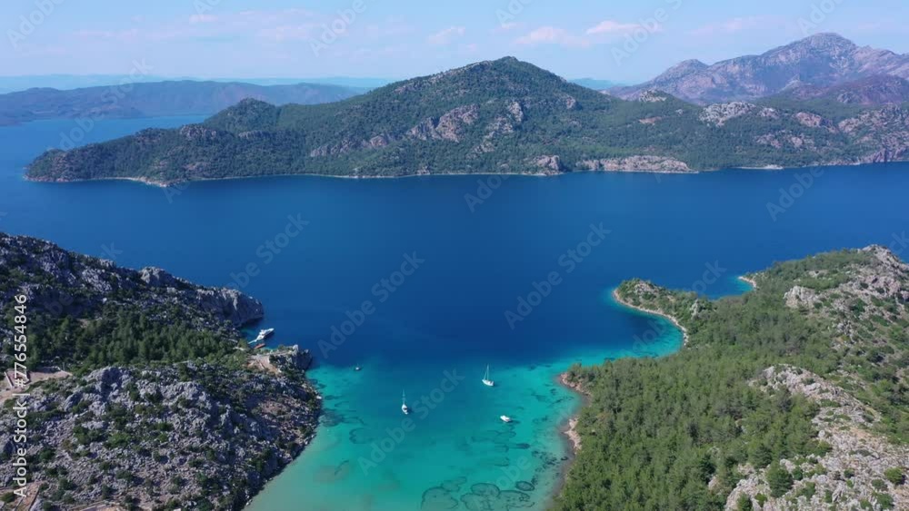 Turquoise bay with a shallow, sandy beach. Pine forest on shore, green mountains in the distance and white clouds in sky. Aerial view of Kumlubük, Selimiye Resort, Marmaris in Turkey
Turquoise bay with a shallow, sandy beach. Pine forest on shore, green mountains in the distance and white clouds in sky. Aerial view of Kumlubük, Selimiye Resort, Marmaris in Turkey
