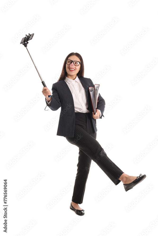Young Asian businesswoman in funny disguise with folders taking selfie on white background Young Asian businesswoman in funny disguise with folders taking selfie on white background