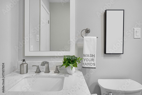 Modern Bathroom Stone Vanity with White Frame Mirror and Empty Photo Frame Mockup, Wash Your Hands Towel photo