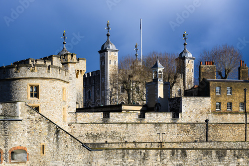 External view of walls and towers of Tower of London under dark sky © IanDewarPhotography