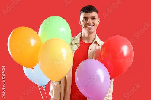 Smiling young man holding c...