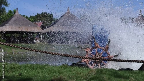 high-speed shooting at 120 frames per second, An aerator with a paddle wheel: Revitalizes a lake or pond, churning up water and increasing the oxygen level in aquatic flora and fauna photo