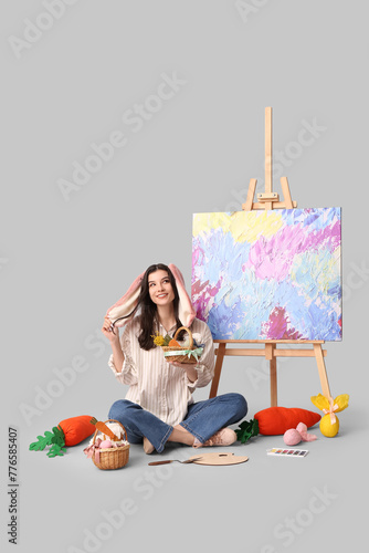 Happy female artist in bunn...