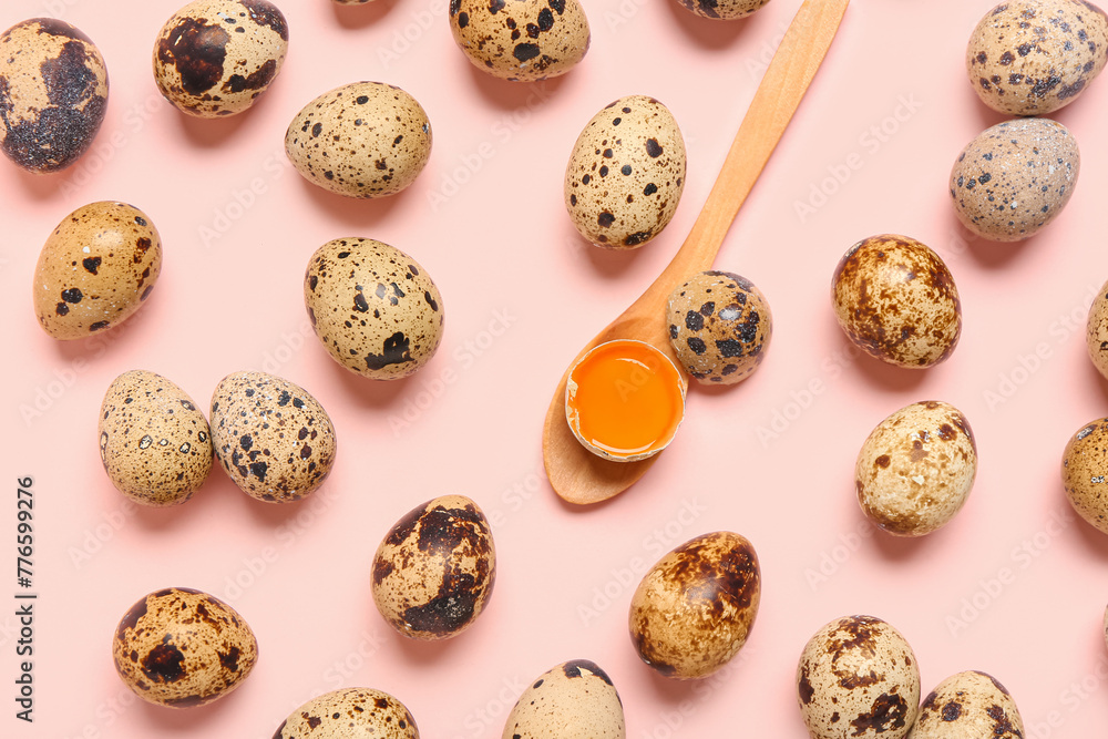 Fresh quail eggs and wooden spoon on pink background