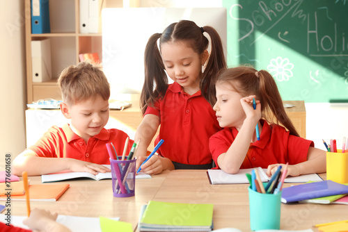 Cute little pupils writing ...