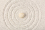 Stone on sand with lines in Japanese rock garden,  top view. Zen concept