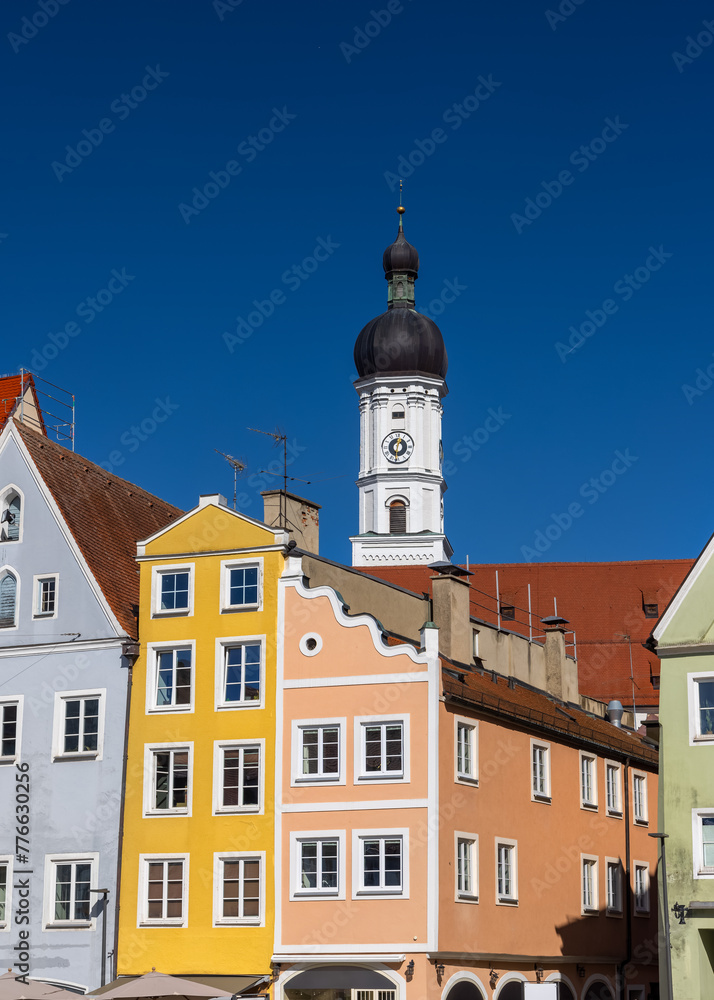Church of the Assumption of Mary and colorful buildings in Landsberg city Germany.