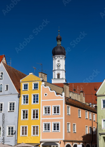 Church of the Assumption of Mary and colorful buildings in Landsberg city Germany.