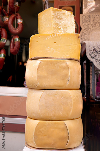 Stack of large cheese rounds at an outdoor market in Izmir, Turkey