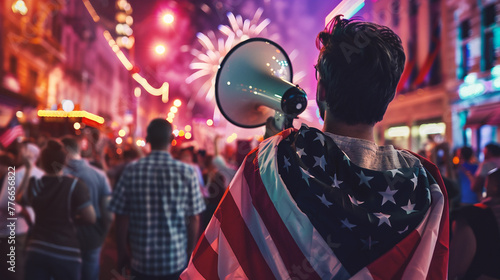 Rear view of young man holding American flag and screaming in megaphone at night