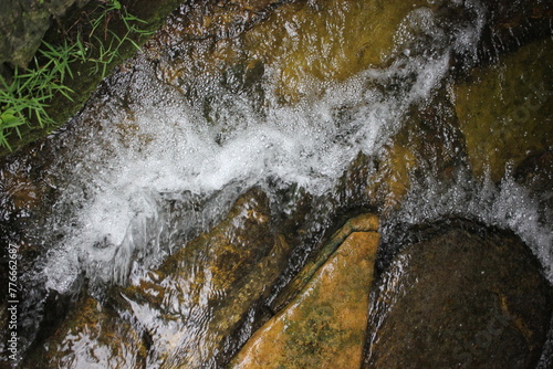 Fresh clean water flowing down the rough rocks.