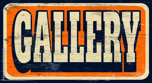 Aged and worn retro gallery sign on wood