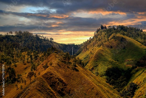sunset in the mountains with waterfall