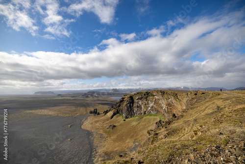 Clouds floating in the sky above the valley, with water reflecting the natural landscape. Cumulus clouds create a stunning horizon view from the top of the mountain. Iceland