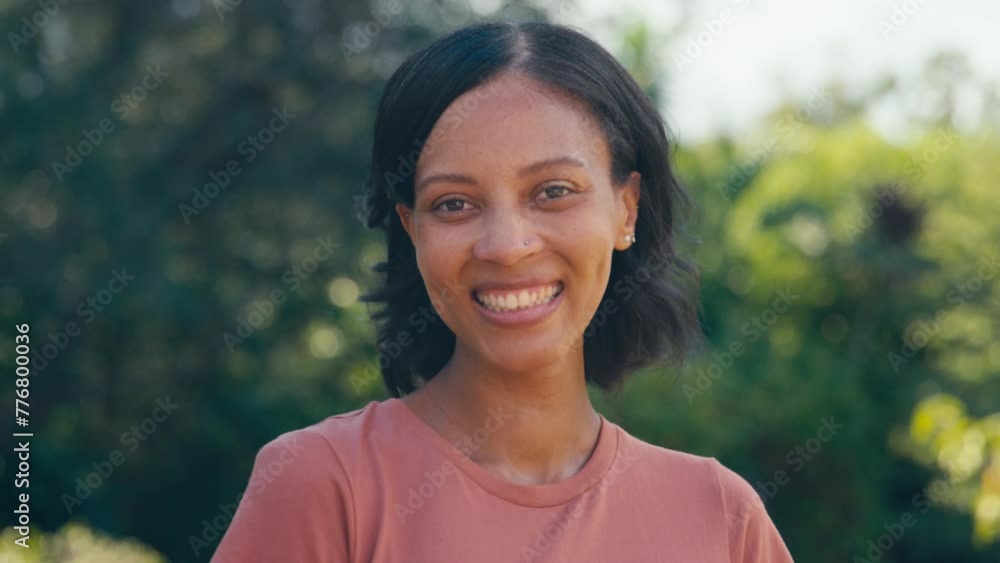 Portrait of smiling woman standing outdoors in summer countryside or garden - shot in slow motion Portrait of smiling woman standing outdoors in summer countryside or garden - shot in slow motion