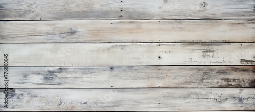 Close-up view of a wooden wall painted white, showcasing the texture and grain of the wood