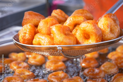 Traditional fried sweets lokma in sugar syrup