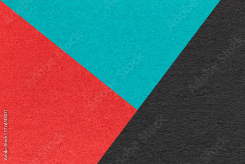 Texture of craft red, turquoise and black paper background, macro. Vintage abstract cerulean cardboard