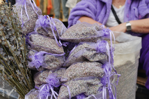 A stack of purple lavender bags fills the basket, creating a beautiful pattern
