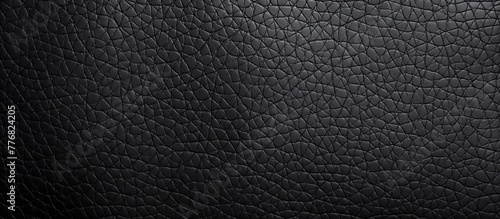 Luxurious black leather background featuring a sophisticated pattern of small squares, adding an elegant touch to any design project