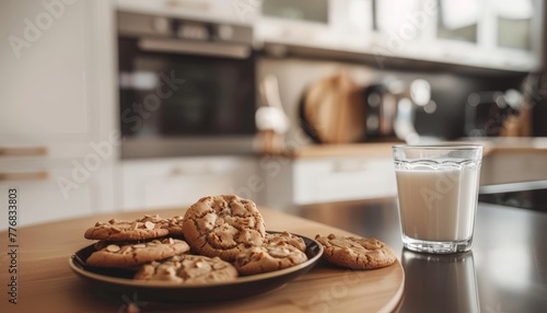a plate of fresh chocolate cookies and a glas of milk on a kitchen counter photo