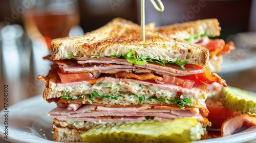 sandwich with ham, cheese and vegetables on a wooden table.