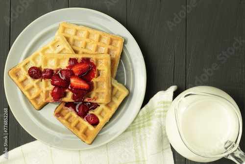 Sweet Belgian waffles covered with jam. Homemade waffles