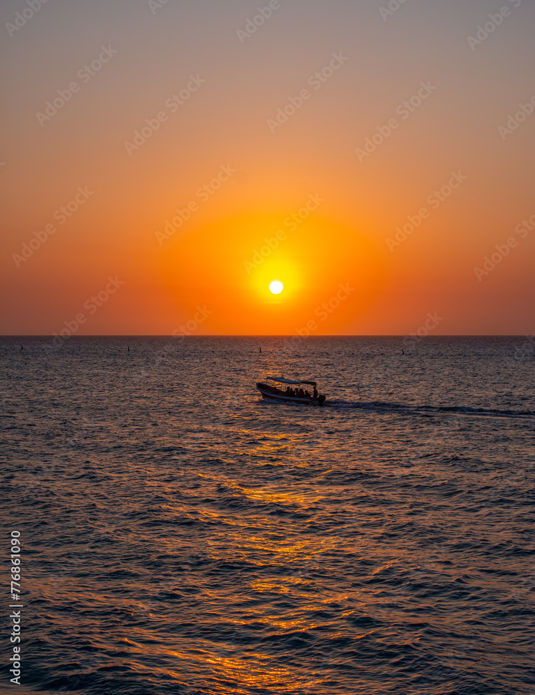 Serene sunset at Playa Blanca with a boat on calm waters