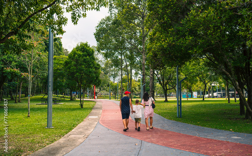 People walking in the Taman Tasik Titiwangsa natural public park in the Kuala Lumpur city, Malaysia