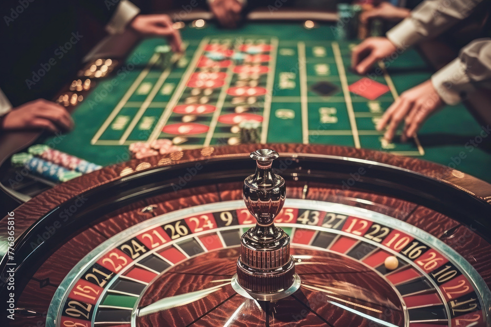 Roulette table in a casino with players placing bets. Roulette table in a casino with players placing bets.
